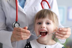 Pediatric dentist working with child